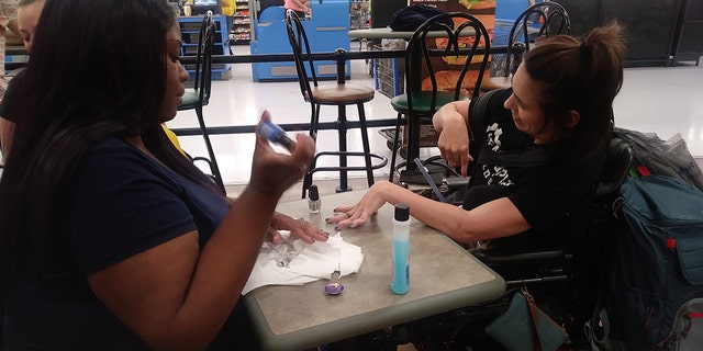 The pair bought a bottle of nail polish and set up a salon at one of the tables at the Walmart.