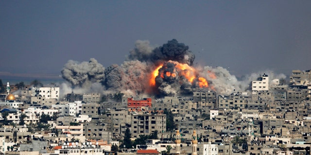 Smoke and fire from the explosion of an Israeli strike rise over Gaza City, Tuesday, July 29, 2014. Israel escalated its military campaign against Hamas on Tuesday, striking symbols of the group's control in Gaza and firing tank shells that shut down the strip's only power plant in the heaviest bombardment in the fighting so far. The plants shutdown was bound to lead to further serious disruptions of the flow of electricity and water to Gazas 1.7 million people. (AP Photo/Hatem Moussa)