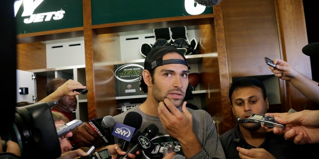Quarterback Mark Sanchez rubs his chin as he listens to a question after New York Jets football practice in Florham Park, N.J., Monday, Sept. 2, 2013.  (AP Photo/Mel Evans)