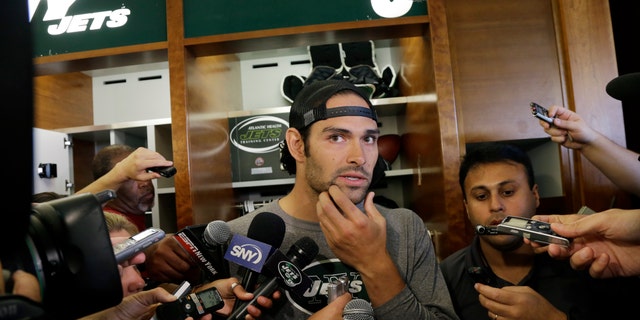 Quarterback Mark Sanchez rubs his chin as he listens to a question after New York Jets football practice in Florham Park, N.J., Monday, Sept. 2, 2013. (AP Photo/Mel Evans)