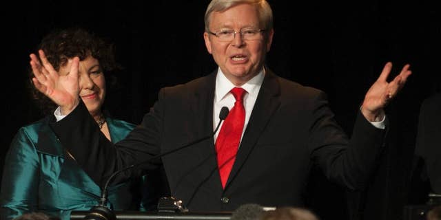 FILE - In this Sept. 7, 2013 file photo, then Australian Prime Minister Kevin Rudd, right, addresses his party members during an Australian Labor Party election night function in Brisbane. Former Australian Prime Minister Kevin Rudd is making a late bid for the top United Nations job, after months of cross-crossing the world in low-key lobbying for government support. Rudd had requested that the Australian government take the crucial step of formally nominating him to succeed U.N. Secretary-General Ban Ki-moon, whose second five-year term ends Dec. 31. At left is his wife Therese Rein. (AP Photo/John Pryke, File)