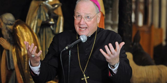 FILE: Jan. 6, 2012: New York Archbishop Timothy Dolan talks after celebrating mass at Saint Patrick's Cathedral in New York City.
