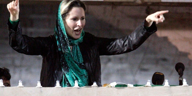 April 15: Aisha Qaddafi, daughter of Libyan leader Muammar al-Qaddafi, encourages Libyan people gathering at the Bab Al Azizia compound in Tripoli, Libya.