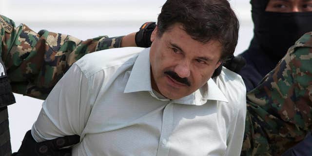 FILE - This Feb. 22, 2014 file photo shows Joaquin "El Chapo" Guzman, the head of Mexico’s Sinaloa Cartel, being escorted to a helicopter in Mexico City following his capture overnight in the beach resort town of Mazatlan.