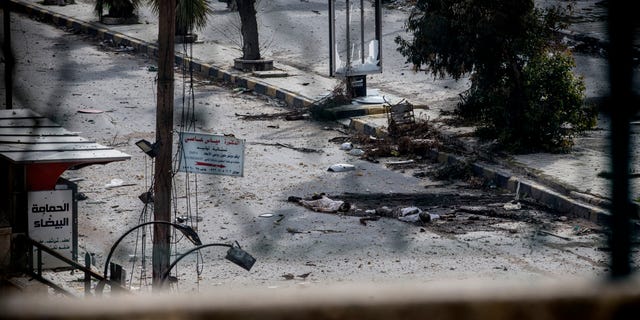 Two dead bodies lie on a street in the Saif al-Dawlah neighborhood of Aleppo, Syria, Sunday, Jan. 13, 2013. The revolution against the Syrian regime started in March 2011 with peaceful protests but morphed into a civil war that has killed more than 60,000 people, according to a recent United Nations estimate. (AP Photo/Andoni Lubaki)