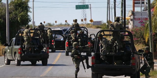 Nov. 19: Mexican soldiers inspect a home as residents flee border towns up and down the Rio Grande valley.