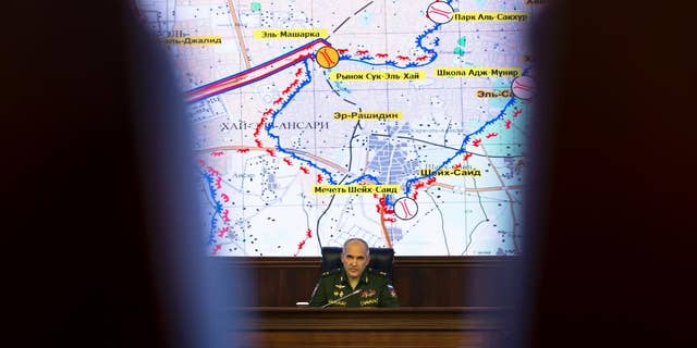 Lt. Gen. Sergei Rudskoi of the Russian military's General Staff speaks in front of a map of the Aleppo area, at a briefing at the Russian Defense Ministry's headquarters in Moscow, Russia, Wednesday, Oct. 19, 2016. The Russian military says that Russian and Syrian warplanes are staying away from Aleppo a day before a temporary pause in the military push declared by Moscow. Lt. Gen. Sergei Rudskoi said the "humanitarian pause" in Aleppo will last from 8 a.m. to 7 p.m. Thursday, three hours longer than the Russian military initially announced. (AP Photo/Alexander Zemlianichenko)