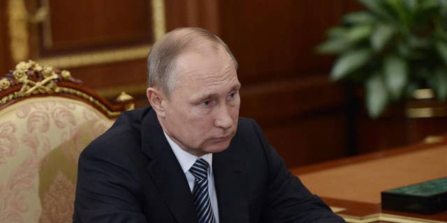 Russian President Vladimir Putin listens during a meeting with VTB CEP Andrei Kostin in Moscow's Kremlin on Tuesday, Sept. 27, 2016. The meeting focused on the current operations of the state-controlled VTB, Russia's second-largest bank. (Alexei Nikolsky/Sputnik, Kremlin Pool Photo via AP)