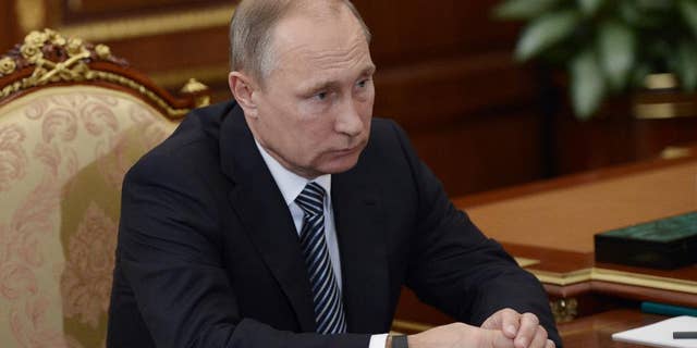 Russian President Vladimir Putin listens during a meeting with VTB CEP Andrei Kostin in Moscow's Kremlin on Tuesday, Sept. 27, 2016. The meeting focused on the current operations of the state-controlled VTB, Russia's second-largest bank. (Alexei Nikolsky/Sputnik, Kremlin Pool Photo via AP)
