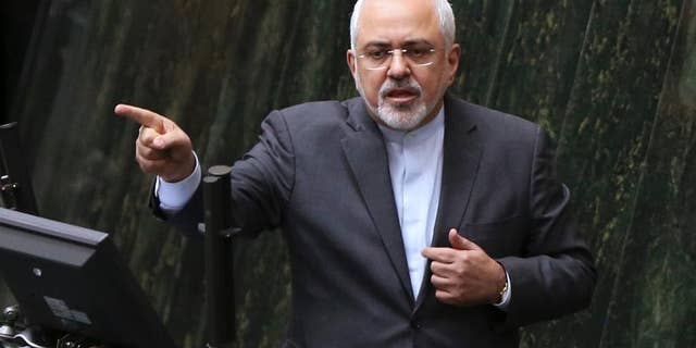 FILE - In this file photo dated Sunday, Oct. 2, 2016, Iranian Foreign Minister Mohammad Javad Zarif answers questions from lawmakers in an open session of parliament in Tehran, Iran, explaining the nuclear deal with world powers. Iran is to receive a huge shipment of natural uranium from Russia to compensate it for exporting tons of reactor coolant, according to unidentified Iranian diplomats Monday Jan. 9, 2017, in a move approved to keep Tehran committed to a landmark nuclear pact. (AP Photo/Vahid Salemi, FILE)