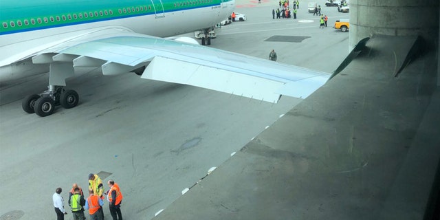 An airport worker at SFO towed an Aer Lingus plane into a concrete pole, resulting in damage to the wing.