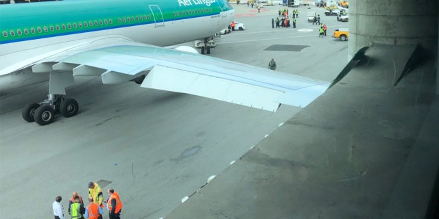 An airport worker at SFO towed an Aer Lingus plane into a concrete pole, resulting in damage to the wing.
