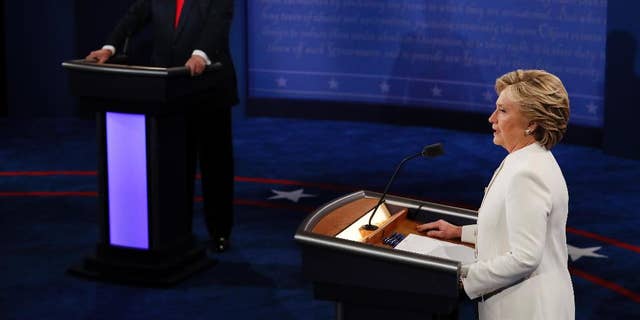 Democratic presidential nominee Hillary Clinton speaks as Republican presidential nominee Donald Trump listens during an October 2016 debate. (Mark Ralston/Pool via AP)