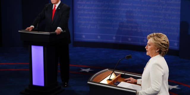 Democratic presidential nominee Hillary Clinton speaks as Republican presidential nominee Donald Trump listens during an October 2016 debate. (Mark Ralston/Pool via AP)