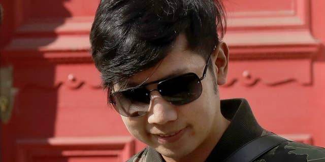 FILE - In this Wednesday, April 15, 2017, file photo, Vorayuth "Boss" Yoovidhya, whose grandfather co-founded energy drink company Red Bull, walks to get in a car as he leaves a house in London. Thai authorities who’ve issued an arrest warrant for the Red Bull heir accused of an alleged hit-and-run that killed a police officer almost five years ago, flew from Bangkok to Singapore two days before he was supposed to appear before prosecutors. (AP Photo/Matt Dunham, File)