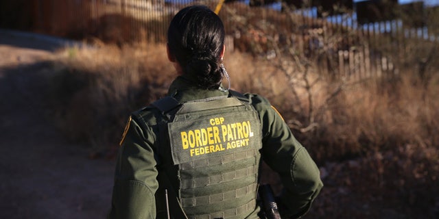 NOGALES, AZ - DECEMBER 09: U.S. Border Patrol agent Nicole Ballistrea watches over the U.S.-Mexico border fence on December 9, 2014 in Nogales, Arizona. (Photo by John Moore/Getty Images)