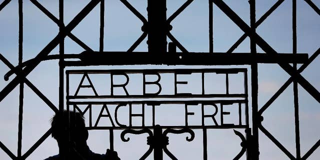 FILE In this April 29, 2015 file picture a  blacksmith prepares a replica of the Dachau Nazi concentration camp gate, with the writing "Arbeit macht frei" (Work Sets you Free) at the main entrance of the memorial in Dachau, Germany,. German police say Friday Dec. 2, 2016 the wrought-iron gate to the Nazis’ Dachau concentration camp that was stolen two years ago appears to have been found in western Norway.  (AP Photo/Matthias Schrader,File)