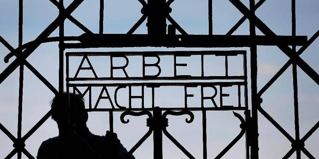 FILE In this April 29, 2015 file picture a blacksmith prepares a replica of the Dachau Nazi concentration camp gate, with the writing "Arbeit macht frei" (Work Sets you Free) at the main entrance of the memorial in Dachau, Germany,. German police say Friday Dec. 2, 2016 the wrought-iron gate to the Nazis’ Dachau concentration camp that was stolen two years ago appears to have been found in western Norway. (AP Photo/Matthias Schrader,File)