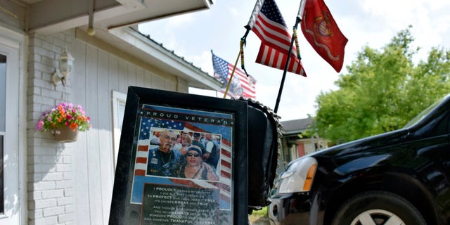 A portrait of Jesus Delgado Rodriguez rests on the seat of a motorcycle in front of his home in New Braunfels, Texas.