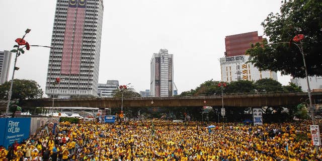 Activists from the Coalition for Clean and Fair Elections (BERSIH) gather on a main road in downtown Kuala Lumpur, Malaysia, during a rally Sunday, Aug. 30, 2015. Big crowds of protesters returned to the streets of Kuala Lumpur on Sunday to demand the resignation of Malaysian Prime Minister Najib Razak over a financial scandal, after the first day of the massive rally passed peacefully. (AP Photo/Joshua Paul)