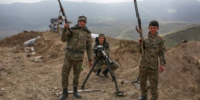 Armenian soldiers pose near a front line in Nagorno-Karabakh, Azerbaijan, Wednesday, April 6, 2016. (Karo Sahakyan/PAN Photo via AP)