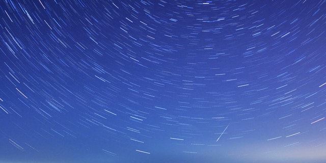 A meteor streaks past stars during the annual Quadrantid meteor shower in Qingdao, Shandong province, Jan. 4, 2014. Picture taken with a long exposure.