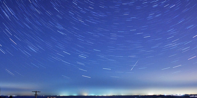 A meteor streaks past stars during the annual Quadrantid meteor shower in Qingdao, Shandong province, Jan. 4, 2014. Picture taken with a long exposure.