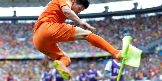 Netherlands' Klaas-Jan Huntelaar celebrates after scoring his side's second goal during the World Cup round of 16 soccer match between the Netherlands and Mexico at the Arena Castelao in Fortaleza, Brazil, Sunday, June 29, 2014. The Netherlands won the match 2-1. (AP Photo/Natacha Pisarenko)