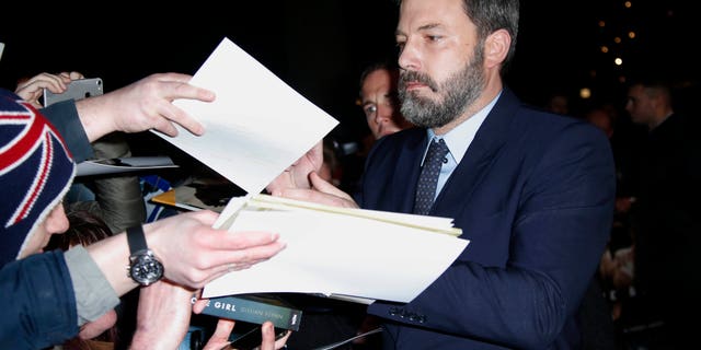 Actor Ben Affleck signs autographs upon arrival at the premiere of the film 'Live By Night' in London, Wednesday, Jan. 11, 2016. (Photo by Joel Ryan/Invision/AP)
