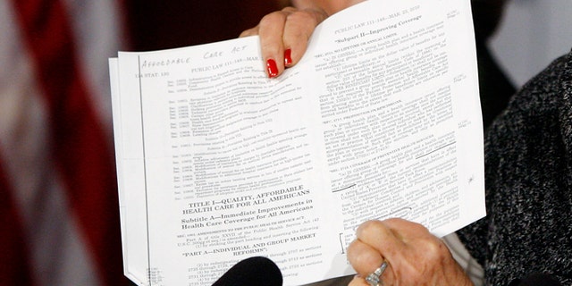 U.S. Senator Barbara Boxer (D-CA) holds a copy of the Affordable Care Act (commonly known as Obamacare) at the U.S. Capitol in Washington, September 30, 2013.