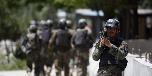 Afghan National Army soldiers arrive at the Kabul's main military hospital in Kabul, Afghanistan, Saturday, May 21, 2011. (AP Photo/Mustafa Quraishi)