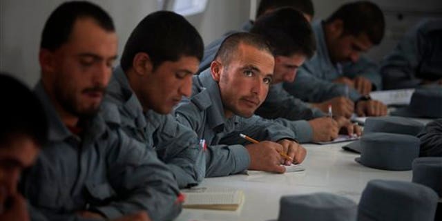 In this Nov. 7 photo, new Afghan police recruits attend a literary class at Central Training Center on the outskirts of Kabul. (AP Photo)
