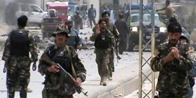 April 6, 2013: This image shows Afghan National Army soldiers rushing to the scene moments after a car bomb exploded in front the PRT, Provincial Reconstruction Team, in Qalat, Zabul province, southern Afghanistan.