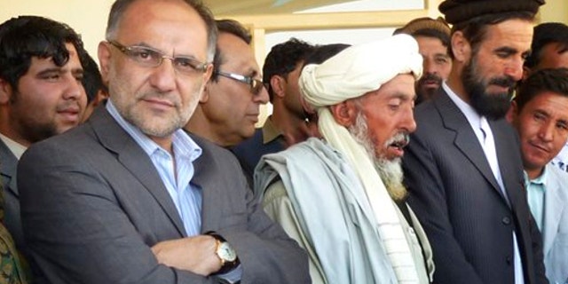 FILE: Oct. 12, 2013: Governor Arsallah Jamal, left, attends an opening ceremony of a school in Muhammad Agha, Logar province, Afghanistan. A bomb planted inside a mosque killed the governor of Afghanistan's eastern Logar province as he was delivering a speech Oct. 15.