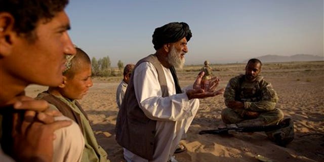 June 27. An Afghan man talks to an American soldier about bringing much needed essential services, such as water and power, to their village. Such services are being provided in the hope of winning over the hearts and minds of the Afghan people. However, intelligence leaders have recently placed a greater emphasis on more traditional ways of targeting the Taliban-led insurgency, such as mapping enemy networks and behavior.