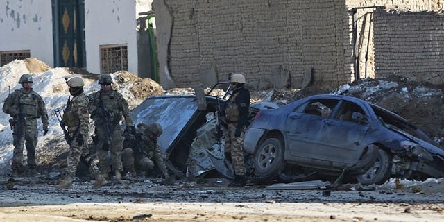Feb. 10, 2014: U.S. soldiers and Afghan security forces search the site of a suicide bombing that struck near a NATO convoy in the Afghan capital Kabul, Afghanistan.