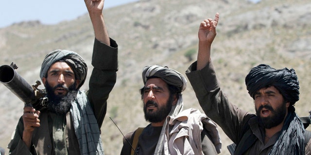 Taliban fighters react to a speech by their senior leader in the Shindand district of Herat province, Afghanistan, in 2016.