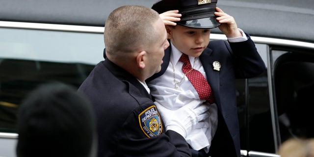 Ryan Lemm, 4, son of Joseph Lemm, arrives for his father's funeral.