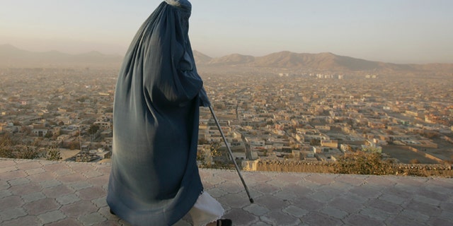 Nov. 11, 2012: An Afghan woman walks on a hill overlooking Kabul, Afghanistan.
