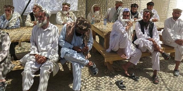 Afghan village elders sit at an Afghan and U.S. Special Forces base in Deh Bala district, Nangarhar province, Afghanistan July 7, 2018.