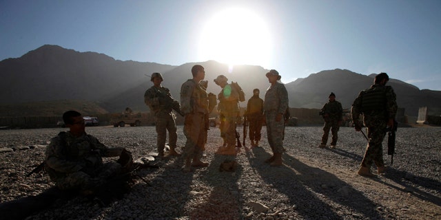 Nov. 22: U.S. Army soldiers and Afghan policemen prepare themselves for a foot patrol in West Now Ruzi village, district Panjwai, in Afghanistan.