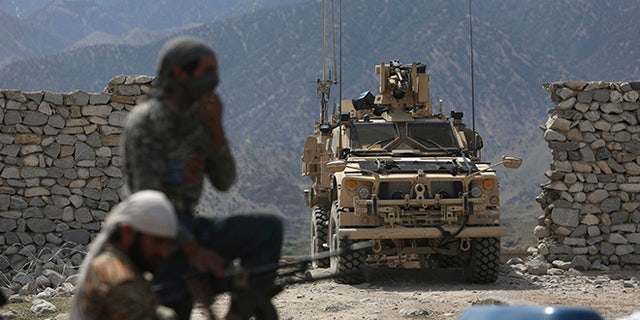 FILE - In this April 17, 2017, file photo, U.S. forces and Afghan security police are seen in Asad Khil near the site of a U.S. bombing in the Achin district of Jalalabad, east of Kabul, Afghanistan. The Pentagon will send almost 4,000 additional American forces to Afghanistan, a Trump administration official said June 15, hoping to break a stalemate in a war that has now passed to a third U.S. commander-in-chief. The deployment will be the largest of American manpower under Donald Trumpâs young presidency. (AP Photo/Rahmat Gul, File)