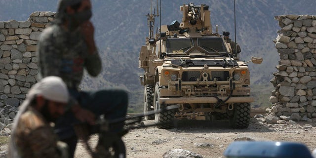 FILE - In this April 17, 2017, file photo, U.S. forces and Afghan security police are seen in Asad Khil near the site of a U.S. bombing in the Achin district of Jalalabad, east of Kabul, Afghanistan. The Pentagon will send almost 4,000 additional American forces to Afghanistan, a Trump administration official said June 15, hoping to break a stalemate in a war that has now passed to a third U.S. commander-in-chief. The deployment will be the largest of American manpower under Donald Trumps young presidency. (AP Photo/Rahmat Gul, File)