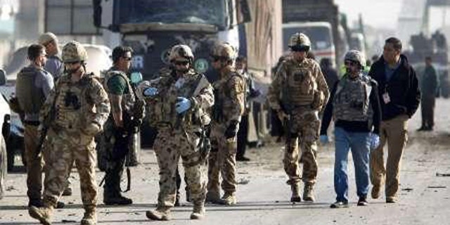 NATO-led troops are seen near a blast site after a suicide bomb attack in Kabul Nov. 13. (Reuters Photo)