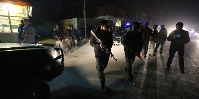 Afghan security forces inspect the site of an explosion in Kabul.
