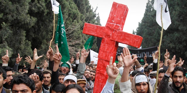 March 13, 2012: Protesters east of Afghanistan's capital of Kabul shout slogans against the United States while carrying a red cross after the killing of 16 Afghan civilians allegedly by an American soldier in Panjwai, in the province of Kandahar.