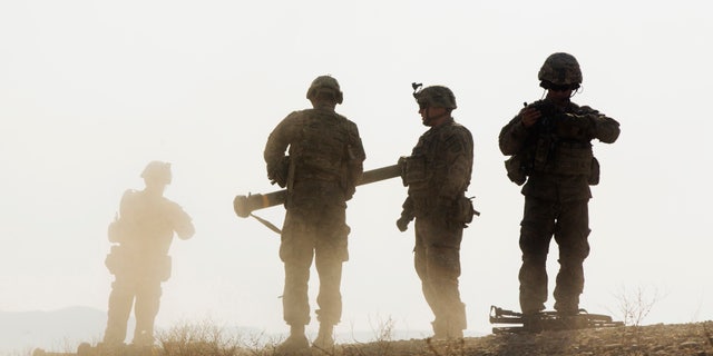 U.S. soldiers from D Troop of the 3rd Cavalry Regiment walk on a hill after finishing with a training exercise near forward operating base Gamberi in the Laghman province of Afghanistan December 30, 2014. REUTERS/Lucas Jackson