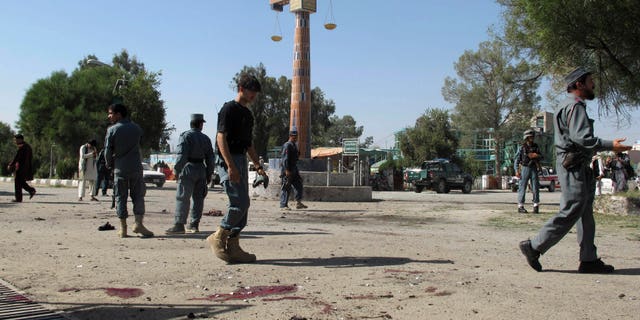 Oct. 1, 2012 - Afghan police secure the site of a suicide bombing in Khost, south of Kabul, Afghanistan.