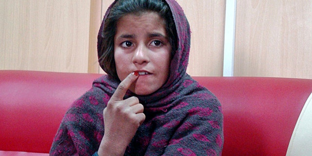 Jan. 6, 2014: In this photo, an Afghan girl named Spozhmai is held in a border police station in the Khan Neshin district in the southeastern part of Helmand province, Afghanistan.