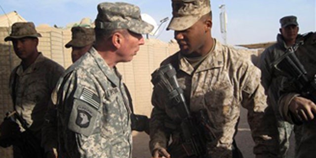 Dec. 25, 2010: Gen. David Petraeus, left, top U.S. and NATO commander in Afghanistan, meets U.S. marines during his visit to Marjah, Afghanistan.